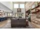 Bright and airy living room featuring a wood accent wall, comfortable seating, and an open floor plan into the dining room at 1525 W Bent Tree Dr, Phoenix, AZ 85085