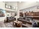 Spacious living room featuring high ceilings, comfortable seating, and an open floor plan flowing into the kitchen at 1525 W Bent Tree Dr, Phoenix, AZ 85085