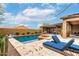 Backyard pool and patio with lounging chairs and covered outdoor living area, perfect for entertaining and relaxation at 1525 W Bent Tree Dr, Phoenix, AZ 85085