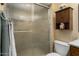 Bathroom featuring a glass-door shower and built in storage cabinet at 15621 N Lakeforest Dr, Sun City, AZ 85351