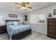 Cozy bedroom features a ceiling fan, and natural light from a window at 15621 N Lakeforest Dr, Sun City, AZ 85351