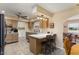 Well-lit kitchen with island seating, tiled floors, and modern appliances, designed for functionality and style at 15621 N Lakeforest Dr, Sun City, AZ 85351