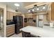 This kitchen features wooden cabinets, stainless steel appliances, and ample counter space with stylish lighting at 15621 N Lakeforest Dr, Sun City, AZ 85351