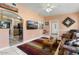 Inviting living room featuring tile floors, comfortable seating, and seamless flow into the kitchen area at 15621 N Lakeforest Dr, Sun City, AZ 85351