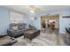 Inviting living room with stylish gray sofa, decorative rug, and smooth flooring, perfect for entertaining at 15621 N Lakeforest Dr, Sun City, AZ 85351