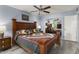 Serene bedroom features a comfortable bed, ceiling fan, and mirrored closet doors for added space at 15621 N Lakeforest Dr, Sun City, AZ 85351