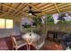 Covered patio with a ceiling fan, seating area, and lattice privacy screen at 15621 N Lakeforest Dr, Sun City, AZ 85351