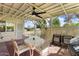 Covered patio with a ceiling fan, seating area, and lattice privacy screen at 15621 N Lakeforest Dr, Sun City, AZ 85351