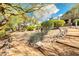 Tranquil backyard features desert plants and foliage, with a rock lined path leading to the home at 16420 N Thompson Peak Pkwy # 1064, Scottsdale, AZ 85260