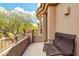 Enjoy a private balcony with a comfortable bench and scenic views of lush greenery and blue skies at 16420 N Thompson Peak Pkwy # 1064, Scottsdale, AZ 85260