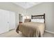 Neutral toned bedroom features a queen bed with wrought iron headboard, and ensuite bathroom access at 16420 N Thompson Peak Pkwy # 1064, Scottsdale, AZ 85260