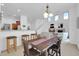 Bright dining area featuring a wooden table, modern lighting, and views into living space at 16420 N Thompson Peak Pkwy # 1064, Scottsdale, AZ 85260