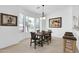 Bright dining area featuring a wooden table, modern lighting, and views into the yard at 16420 N Thompson Peak Pkwy # 1064, Scottsdale, AZ 85260