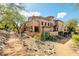 Beautiful desert landscaping surrounds this multi-story condo, with a winding path leading to the entrance at 16420 N Thompson Peak Pkwy # 1064, Scottsdale, AZ 85260