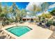 Relaxing hot tub area with desert landscaping, seating, and views of the community pool and clubhouse at 16420 N Thompson Peak Pkwy # 1064, Scottsdale, AZ 85260