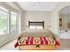 Bright bedroom with a large window, ceiling fan, and decorative chest at the foot of the bed at 16420 N Thompson Peak Pkwy # 1064, Scottsdale, AZ 85260