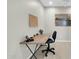 Simple office design featuring a desk, chair, and a corkboard on the wall, lit by a ceiling fan at 16420 N Thompson Peak Pkwy # 1064, Scottsdale, AZ 85260