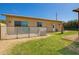 Backyard featuring green grass and fenced patio with desert landscaping at 17203 E Starflower Ct, Queen Creek, AZ 85142