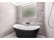 Modern tub in bathroom with gray accent wall at 17203 E Starflower Ct, Queen Creek, AZ 85142