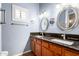 Bathroom features a dual sink vanity, granite countertops, brushed nickel fixtures, and a large vanity mirror at 17203 E Starflower Ct, Queen Creek, AZ 85142