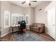 Bedroom featuring a modern desk area, comfortable couch, and neutral tones for a relaxing atmosphere at 17203 E Starflower Ct, Queen Creek, AZ 85142