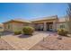 Inviting front entrance with stone pillars and lush landscaping enhances the home's curb appeal at 17203 E Starflower Ct, Queen Creek, AZ 85142