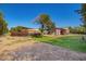 A large horse property with shelters and corrals against a clear, blue sky in a serene setting at 17203 E Starflower Ct, Queen Creek, AZ 85142