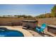 Backyard featuring a relaxing hot tub adjacent to the pool area for ultimate relaxation at 17203 E Starflower Ct, Queen Creek, AZ 85142