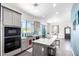 This kitchen features a marble island, grey cabinets, and stainless steel appliances at 17203 E Starflower Ct, Queen Creek, AZ 85142