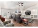 Spacious living room with a stone fireplace, entertainment center, and comfortable seating at 17203 E Starflower Ct, Queen Creek, AZ 85142