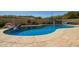 Beautiful freeform pool with waterfall feature, tanning ledge, and stone surround at 17203 E Starflower Ct, Queen Creek, AZ 85142