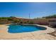 Inviting backyard pool featuring a hot tub, patio area, and lush landscaping at 17203 E Starflower Ct, Queen Creek, AZ 85142