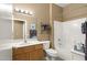 Well-lit bathroom with a single sink vanity, mirror, and shower-tub combo at 17335 W Gould Mine Ln, Surprise, AZ 85387