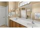 Bathroom featuring a double sink vanity with large mirror and towel racks at 17335 W Gould Mine Ln, Surprise, AZ 85387