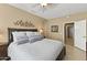 Comfortable bedroom with a ceiling fan, open doorway, and an artful wall decoration at 17335 W Gould Mine Ln, Surprise, AZ 85387