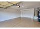 This garage features a durable epoxy floor and ample space for storage and vehicles at 17335 W Gould Mine Ln, Surprise, AZ 85387