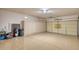 Spacious two car garage featuring storage cabinets and an epoxy floor at 17335 W Gould Mine Ln, Surprise, AZ 85387