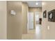 Inviting hallway with neutral paint, tile flooring, and white doors at 17335 W Gould Mine Ln, Surprise, AZ 85387