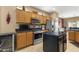 Kitchen with stainless steel appliances, wooden cabinetry, and central island at 17335 W Gould Mine Ln, Surprise, AZ 85387