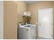 Bright laundry room equipped with a washer, dryer, and overhead storage at 17335 W Gould Mine Ln, Surprise, AZ 85387