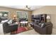 Inviting living room featuring tile floors, a ceiling fan, and natural light at 17335 W Gould Mine Ln, Surprise, AZ 85387