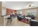 Open-concept living area featuring a dining table and breakfast bar, perfect for entertaining at 17335 W Gould Mine Ln, Surprise, AZ 85387