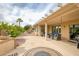 This covered patio features outdoor seating, lush landscaping, and a peaceful outdoor setting at 17335 W Gould Mine Ln, Surprise, AZ 85387