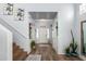 Bright entryway with wood-look flooring and staircase at 17423 W Yavapai St, Goodyear, AZ 85338