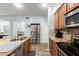 Modern kitchen featuring stainless steel appliances, granite countertops and wood tile flooring at 17423 W Yavapai St, Goodyear, AZ 85338