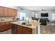 Well-equipped kitchen featuring granite countertops, stainless steel appliances, and an open view into the living room at 17423 W Yavapai St, Goodyear, AZ 85338