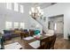 Bright living room with soaring ceilings, an open-concept dining area, and a staircase to the second floor at 17423 W Yavapai St, Goodyear, AZ 85338