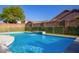 Inviting pool with a cascading waterfall and lush landscaping at 17423 W Yavapai St, Goodyear, AZ 85338