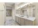 Bright bathroom with dual vanity, tile floor, and a well-lit mirror at 17882 N Painted Spurge Ct, Surprise, AZ 85374