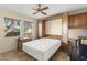 Bedroom with built in cabinet/bed combo, a ceiling fan and two windows at 17882 N Painted Spurge Ct, Surprise, AZ 85374